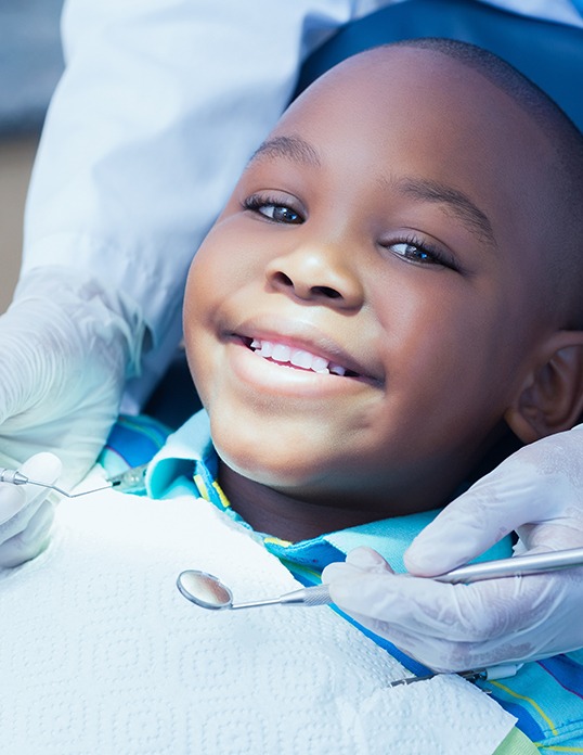 Young boy smiling after receiving tooth-colored fillings in Castle Rock