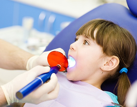 Little girl receiving tooth-colored fillings