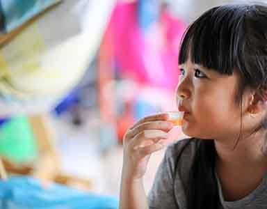 Young girl taking liquid medicine 