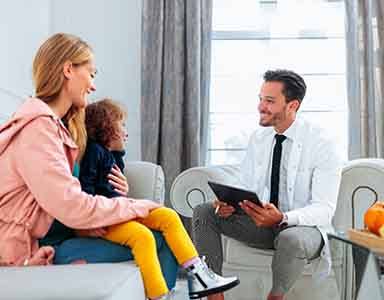 Dentist speaking to mother and daughter 